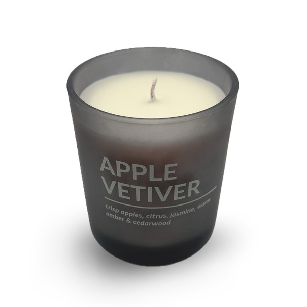 A clear, isolated product shot of the Apple Vetiver candle in its matte black glass jar against a plain white background.