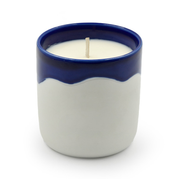 The unlit Summer Days candle is shown in its blue and white ceramic canister against a plain white background.