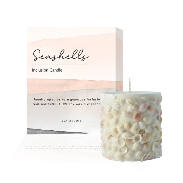 The Seashells Inclusion Candle is displayed as a complete gift set, shown next to its elegant, branded gift box.