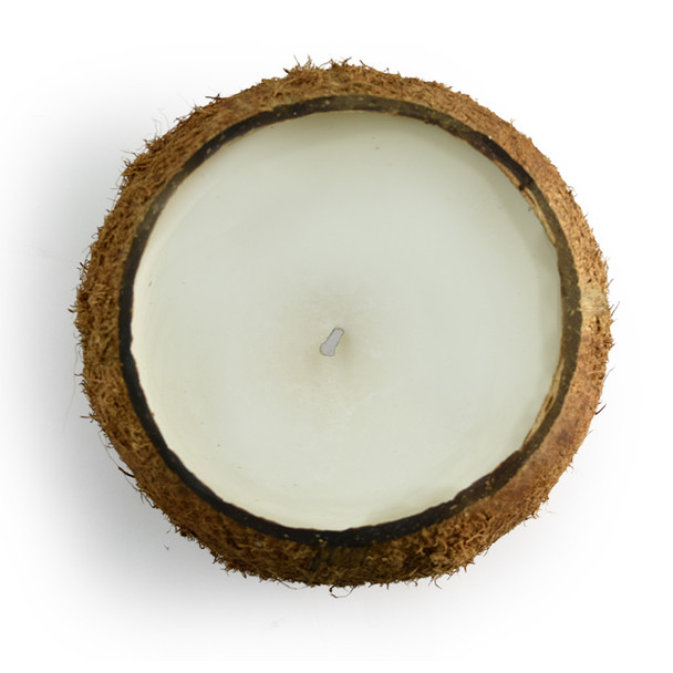 A top-down view of the unlit candle, showing the single wick centered in the smooth, cream-colored coconut and soy blend wax.