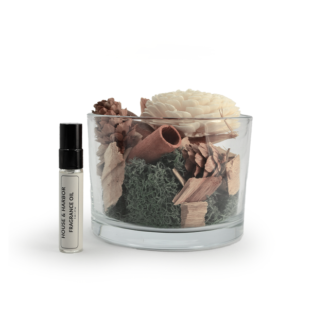 The complete House & Harbor Potpourri Diffuser set is shown against a white background, including the glass container filled with botanicals and the accompanying bottle of fragrance oil.