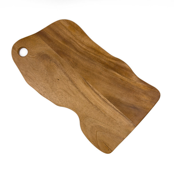 A natural edge walnut wood cutting board shown at an angle, emphasizing its organic contours and wood grain.