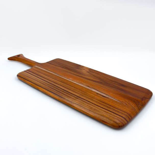 A teak paddle board displayed on a clean white background, highlighting its shape and handle.