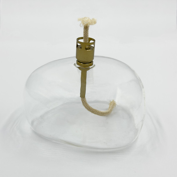 An angled view of the unlit glass table top torch against a white background, highlighting its modern, organic shape. An angled view of the unlit glass table top torch against a white background, highlighting its modern, organic shape.