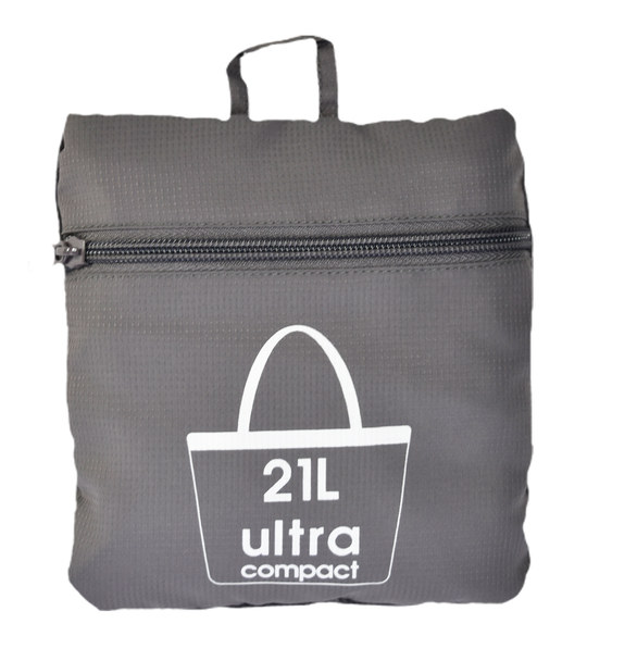 The Navigator Tote is shown in its ultra-compact, folded state, zipped neatly into its self-containing storage pouch against a white background.