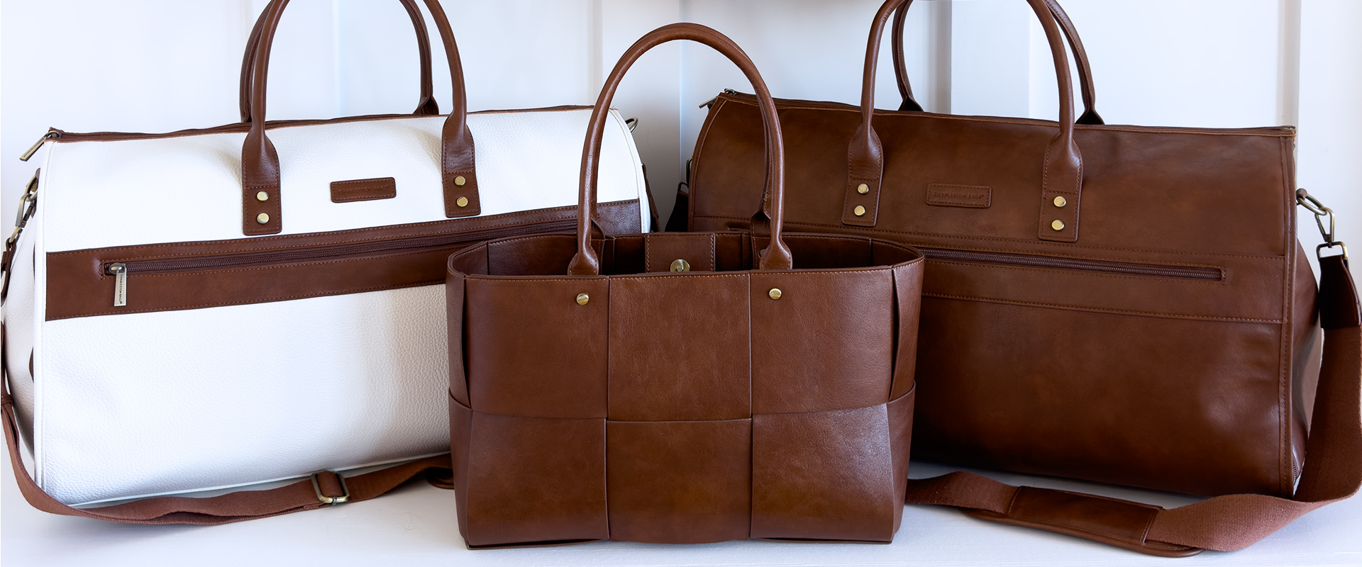Three different vegan leather bags arranged on a shelf, highlighting their diverse shapes and textures.