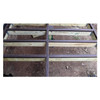 Top-down view of a wooden deck frame with brown joist tape applied to the top of the lumber to prevent moisture rot.