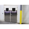 Grey and yellow column guard installed on a structural pillar next to double metal-clad industrial doors.