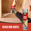 Person applying spray foam sealant to a rim joist in a residential basement to create an airtight insulation seal.