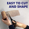 showing a person using scissors to cut a roll of copper mesh, demonstrating it is easy to cut and shape.