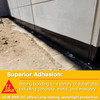 Infographic showing black waterproofing membrane applied to the base of a concrete wall with text explaining superior adhesion to concrete, metal, and masonry.