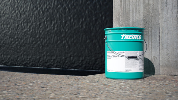 Teal metal pail of polyurethane waterproofing membrane sitting next to a concrete wall with a finished black waterproof coating.