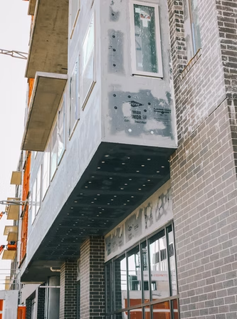 Air and vapor barrier insulation system installed on exterior building facade under construction.