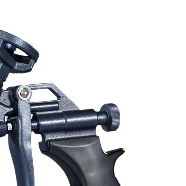 Close-up view of the flow adjustment knob and trigger mechanism on a dark grey spray foam gun.