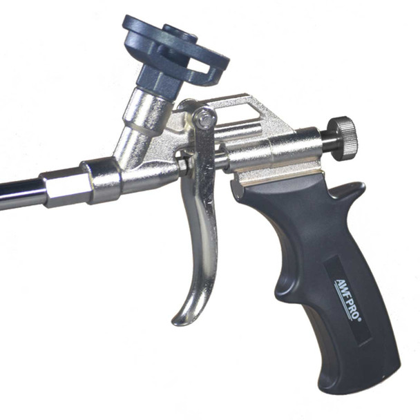 Close-up view of the metallic body, trigger, flow control knob, and black handle on a silver spray foam gun.