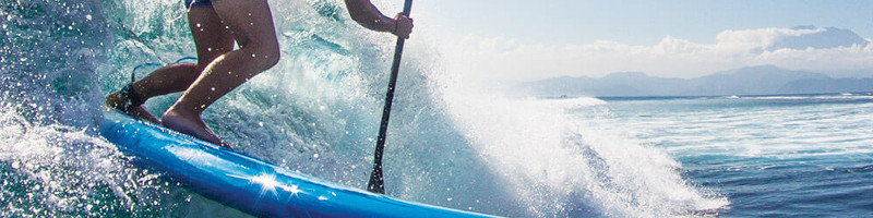 Lady carving on her surf SUP