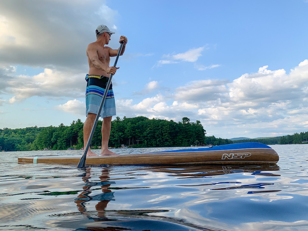 Man enjoying a paddle after purchasing one of our used paddle boards