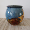 Blue ceramic urn with sunflowers
