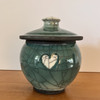 Handmade raku pet urn with heart design. medium size urn capacity.
Green and white crackle glaze. 