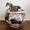 Custom horse hair pottery urns with hand sculpted horse on lid of the urn. Porcelain hand sculpted and horse hair pottery memorial urns.