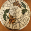 Lid of the sunflower urn with two smaller hand painted sunflowers on either side of the lid knob.