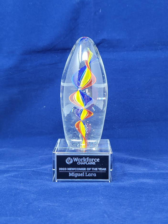 Colorful egg-shaped art glass award with clear glass base