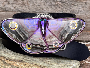 The buckle features Lapidary Lace Agate Doublets, Salon Sapphires, and a delicately carved Glass Moth Body with Ethiopian Opal Eyes. Hand-forged Sterling Silver