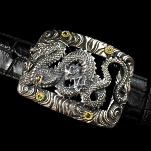 Handmade Sterling Silver Dragon with 18K Flowers & Tsavorites Buckle. This exquisite buckle showcases a meticulously crafted dragon design adorned with 18K gold flowers and tsavorite gemstones.  JWCooper.com