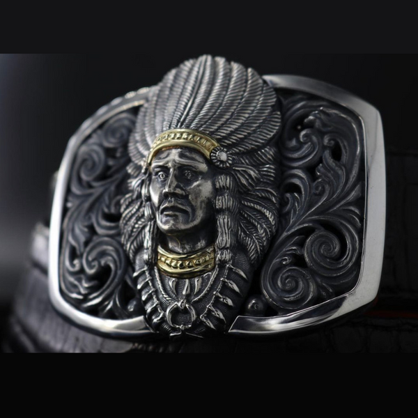 The image showcases a breathtaking Sterling Silver Indian Chief Buckle with 18K Accents, a true masterpiece that pays tribute to Native American culture and artistry. The buckle is captured in stunning detail, highlighting its intricate design and impeccable craftsmanship.