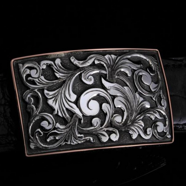 The image showcases a captivating buckle featuring a swirling design in 14K white gold. The buckle is presented against a clean background, allowing the intricate details of the design to stand out. The swirling pattern creates a sense of movement and adds a touch of elegance to the buckle.  jwcooper.com