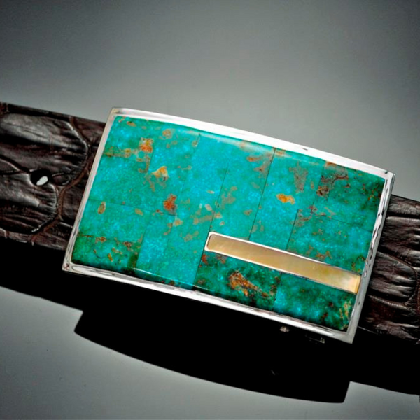 A beautiful Native American hand made sterling silver buckle made of green turquoise inlay with a yellow Mother of Pearl accent line. JWCooper.com