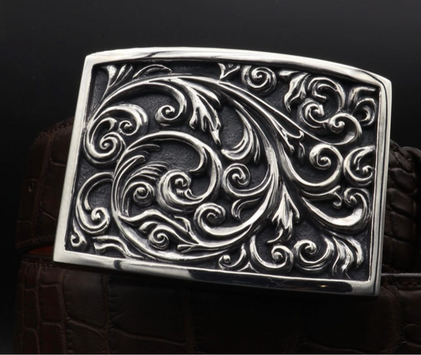 The Sterling Carved Scroll Buckle is a work of exquisite craftsmanship. Expertly cast from a hand-made original, this buckle showcases deeply carved scroll work that adorns its entire surface with the polished border of the buckle. JWCooper.com 