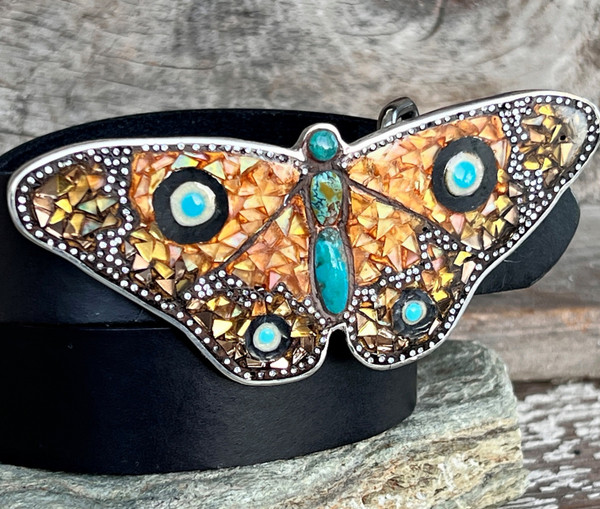 A one-of-a-kind butterfly buckle. Crafted with precision and passion, this buckle features a dazzling mosaic glass design, enriched with vibrant enamel accents and adorned with the timeless beauty of turquoise