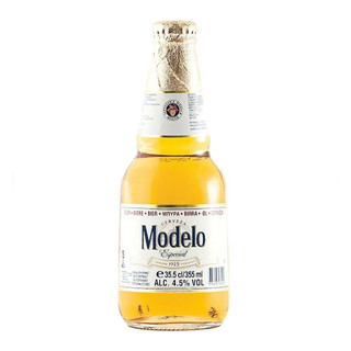A short, contemporary bottle with a gold foil around the neck. The Modelo name sits central against a white and gold label.