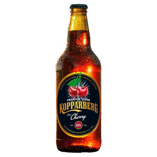 A single amber-hued bottle with a black oval label around the body, outlined in gold, the Kopparberg name is written in gold.