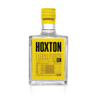 A single transparent bottle with a striking yellow cap and label, with Hoxton written against it in bold black letters.