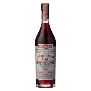 A single transparent bottle with a white and red label wrapped around the body. The Luxardo name is printed in gold.