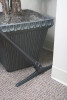A sidewinder tool between a wall and a potted plant.