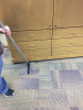 The sidewinder under a cabinet cleaning up dirt.