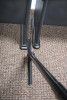 Sidewinder cleaning small space between two desks.