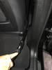 Crevice tool cleaning in between a seat and door in a car.