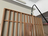 Reach with Sidewinder brush cleaning religious wooden mural.