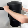 Person installing vacuum hose on the side of Aeon vacuum.