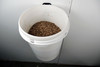 Wood pellets in wall mounted bucket.