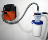 Vacuum and Quick Click separator bucket mounted onto wall and connected via hose.