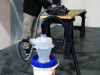 Quick Click separator bucket connected to circular saw on table.