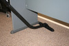 A floor brush attached to an S-Wand cleaning carpet under a desk.
