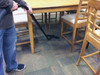 Person cleaning carpet using S-wand and carpet tool.