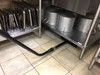 Cleaning under kitchen shelves using an S-wand and floor brush.