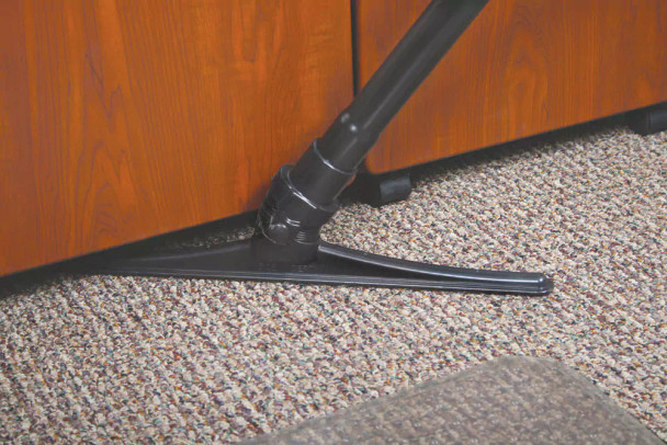 The sidewinder under a cabinet cleaning up dirt.